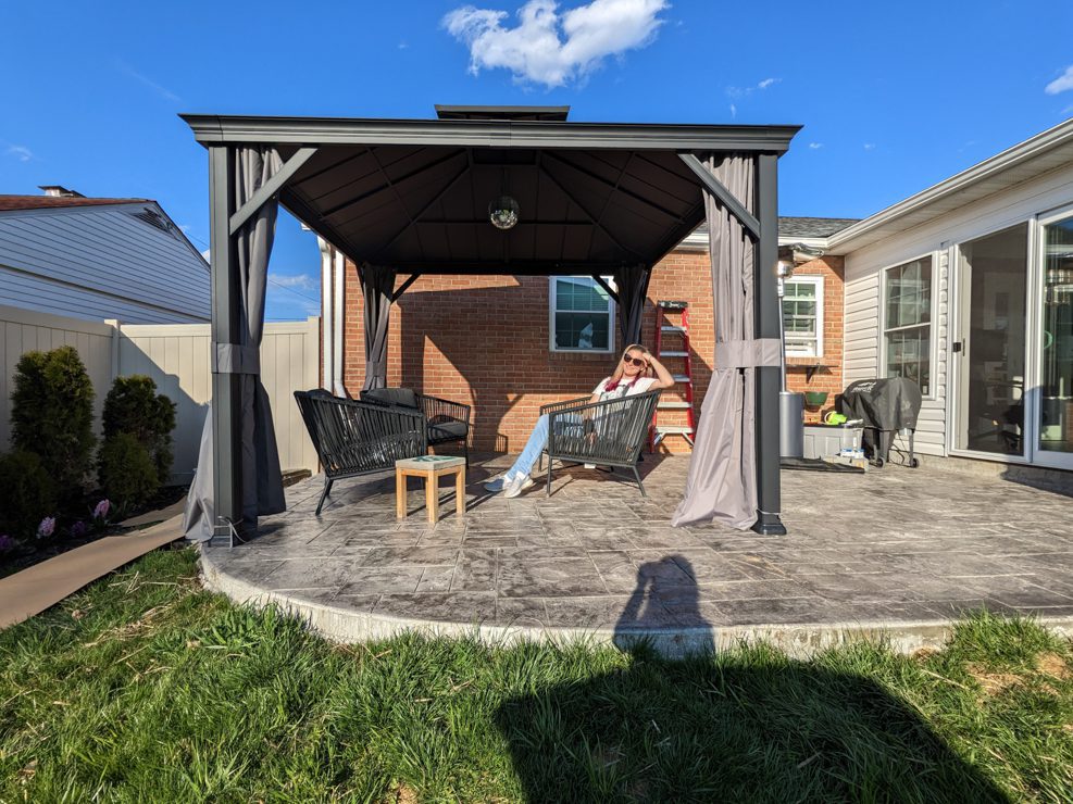 woman sitting in a gazebo on an empty patio