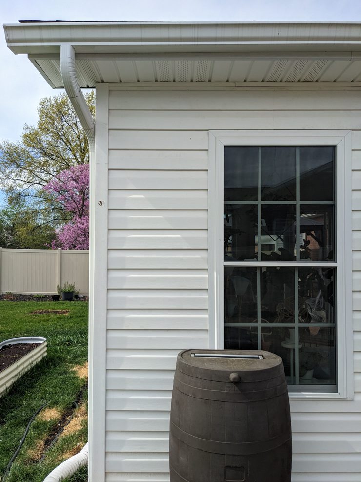 rain barrel against a house