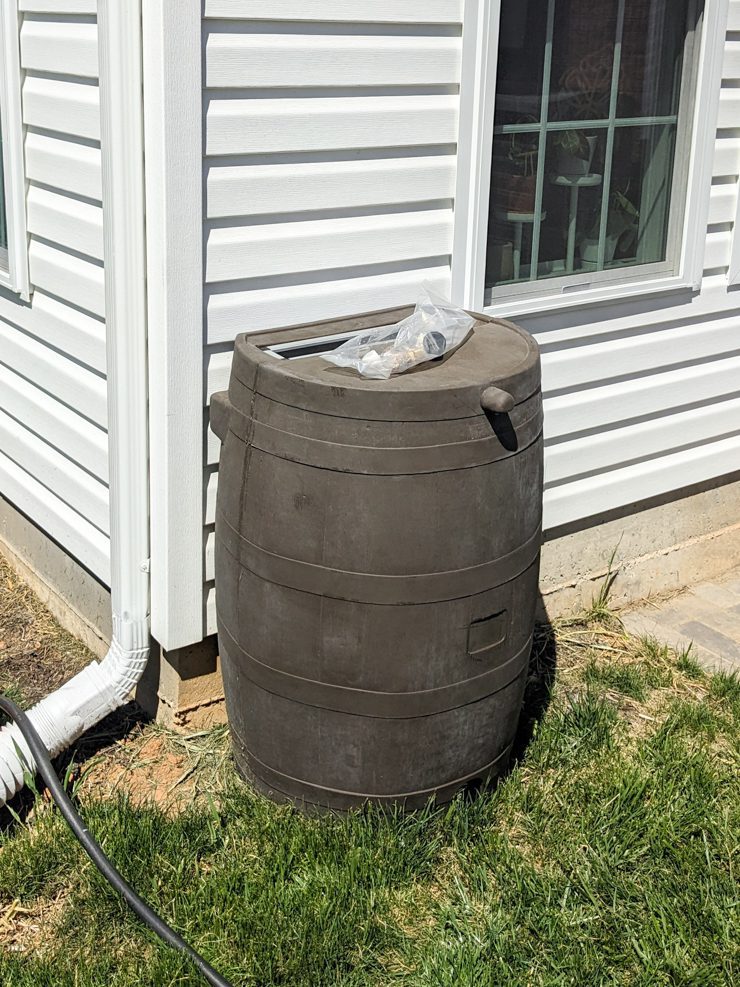 rain barrel sitting in a yard
