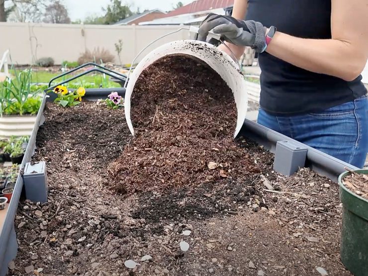 filling a raised garden bed