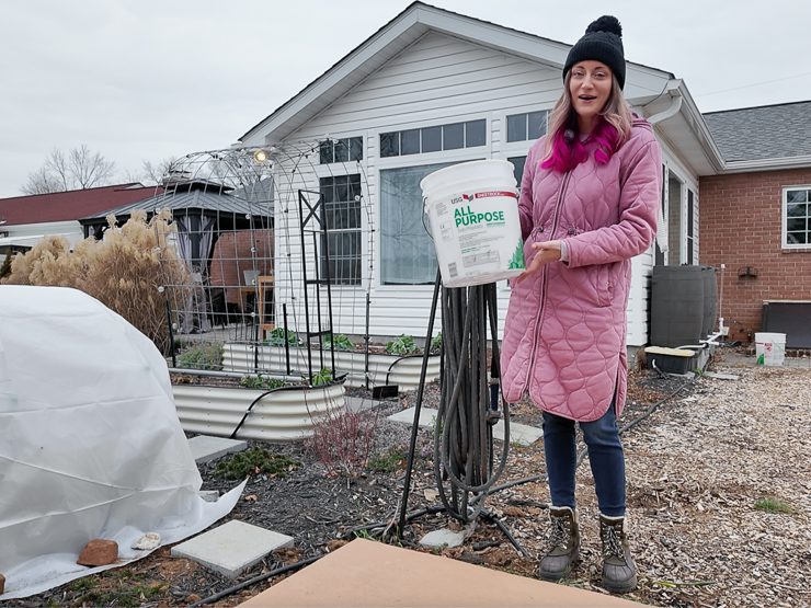 woman holding a 5-gallon bucket