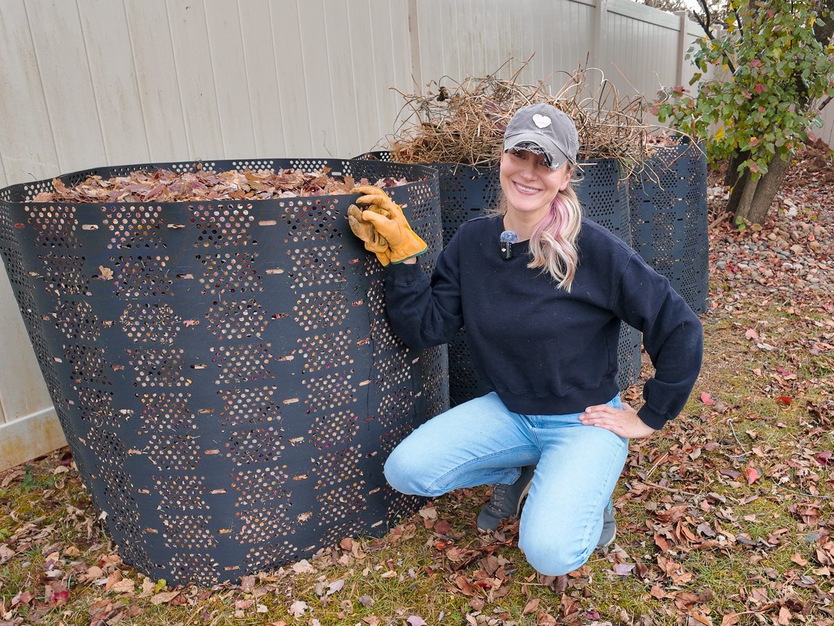 woman next to a leaf compost bin