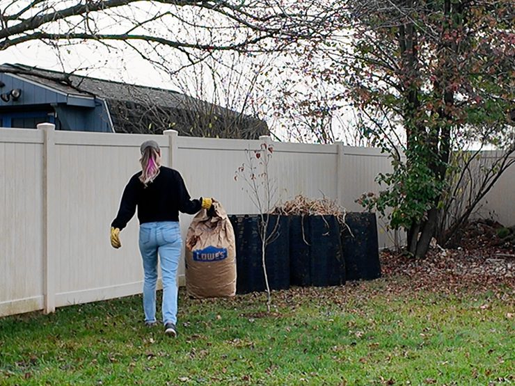 woman holding a bag of leaves