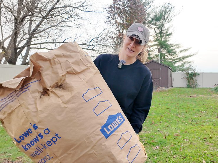 woman holding a bag of leaves