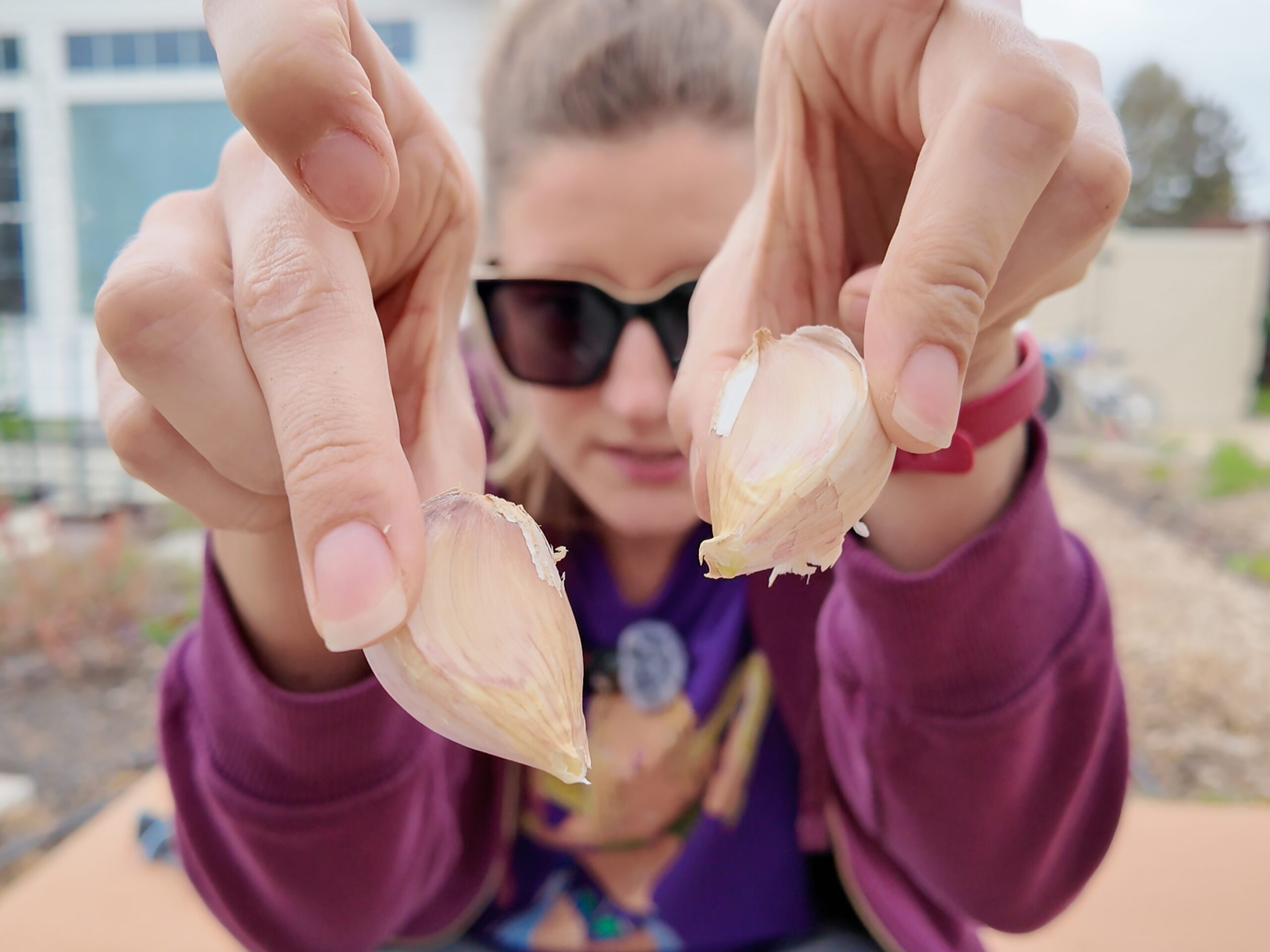 woman holding garlic cloves
