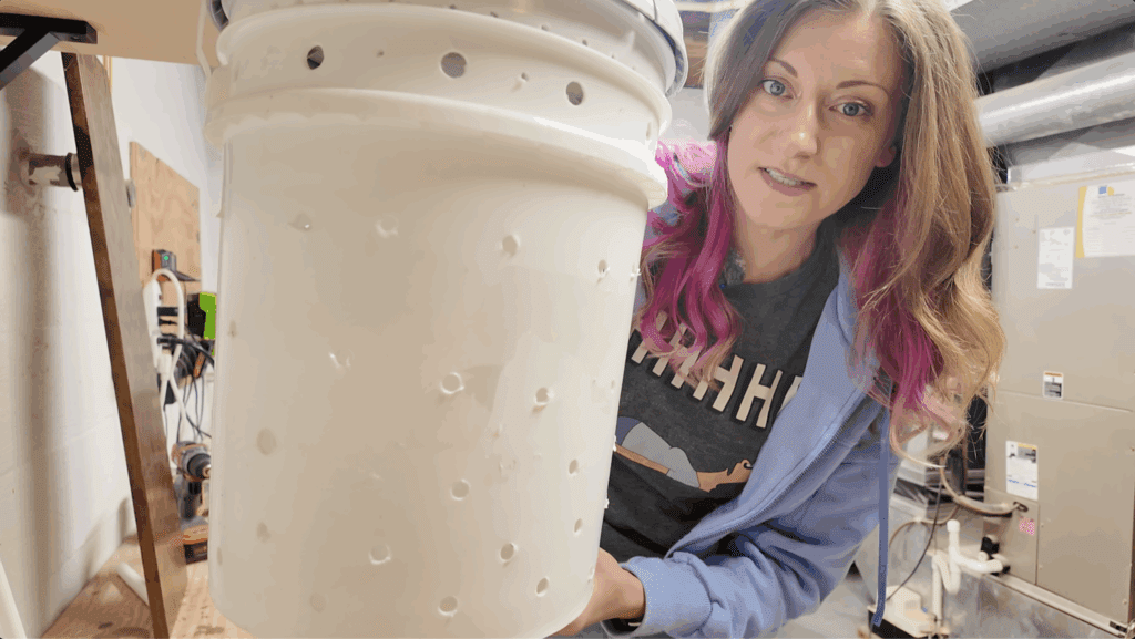 woman holding a bucket with holes in it