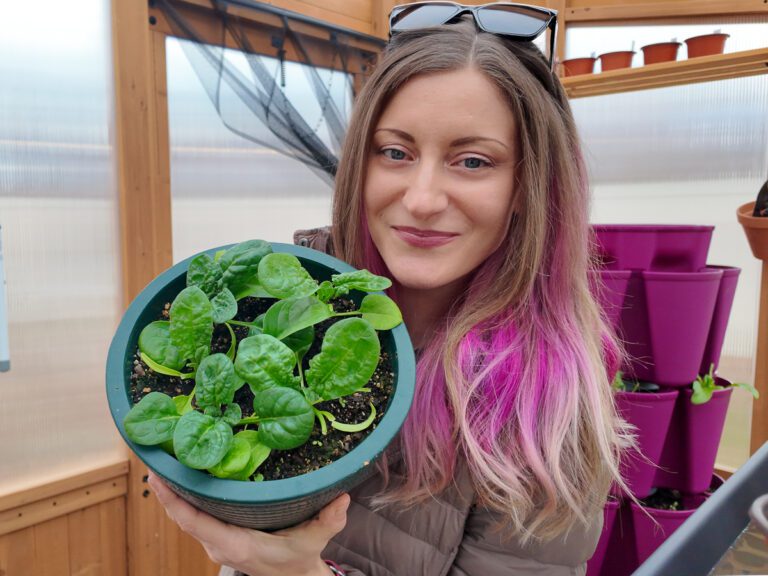 woman holding a pot of spinach